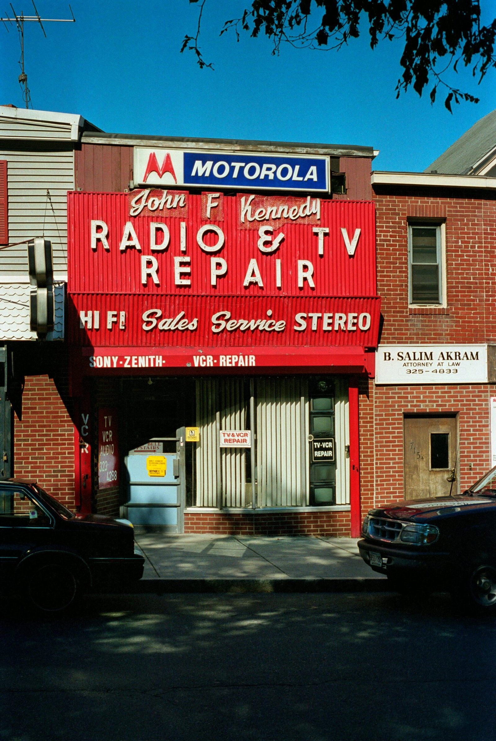 Retro storefront of a radio and TV repair shop in Boston with vibrant signage.